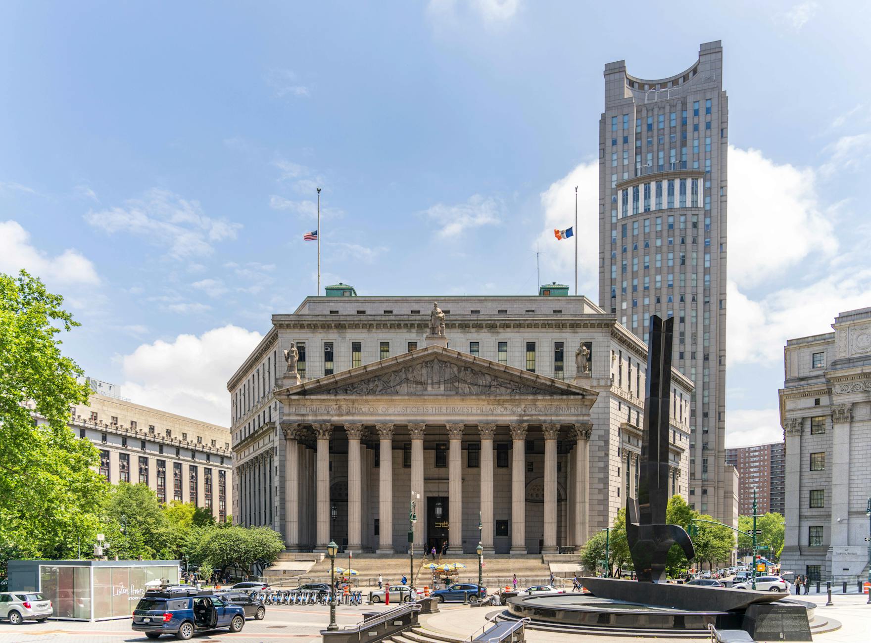 View of the historic New York County Courthouse with clear skies and cityscape.