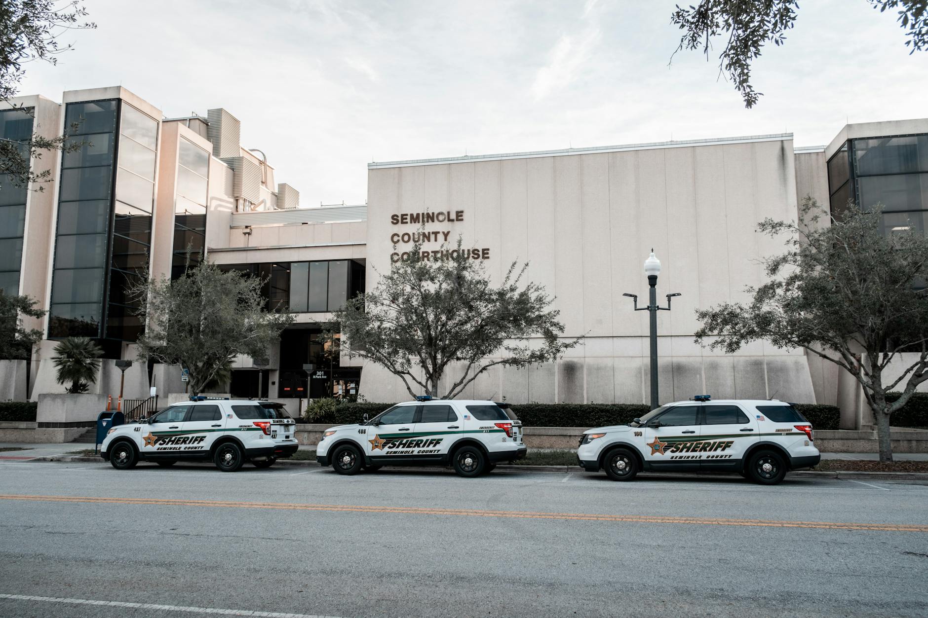 Sheriff vehicles parked in front of Seminole County Courthouse during the day.